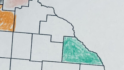 A printed out map zoomed in on southeast Minnesota. Winona County has been colored in with a green colored pencil. The some of the metro counties, on the edge of the image, have been colored as well.